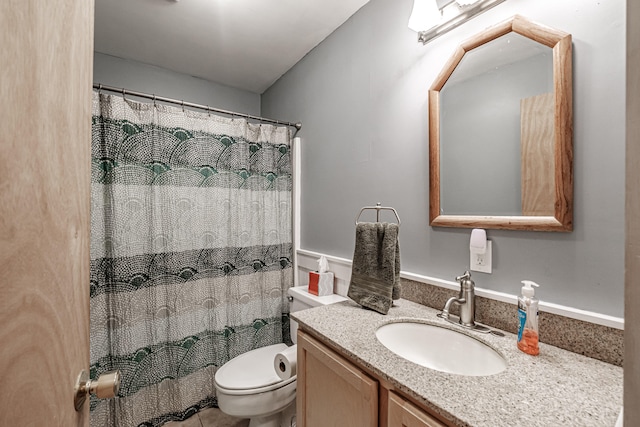 bathroom featuring vanity, toilet, and a shower with shower curtain