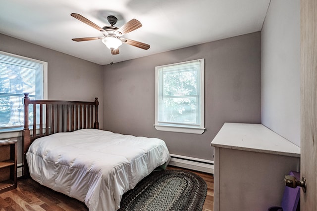 bedroom with ceiling fan, baseboard heating, and hardwood / wood-style floors