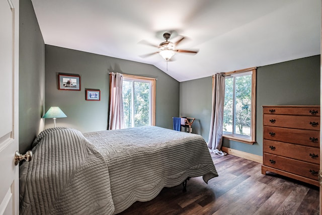 bedroom with ceiling fan, lofted ceiling, and dark hardwood / wood-style floors