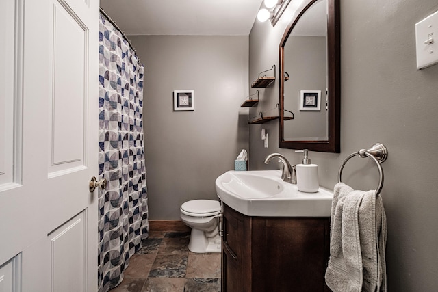 bathroom featuring vanity, toilet, and a shower with shower curtain