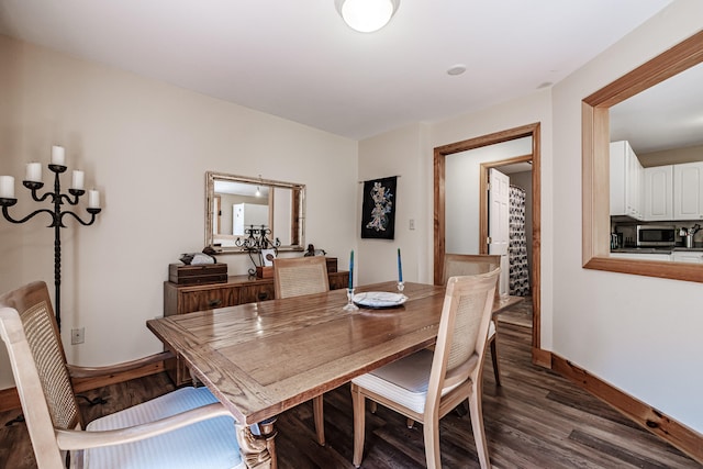 dining room with dark hardwood / wood-style flooring