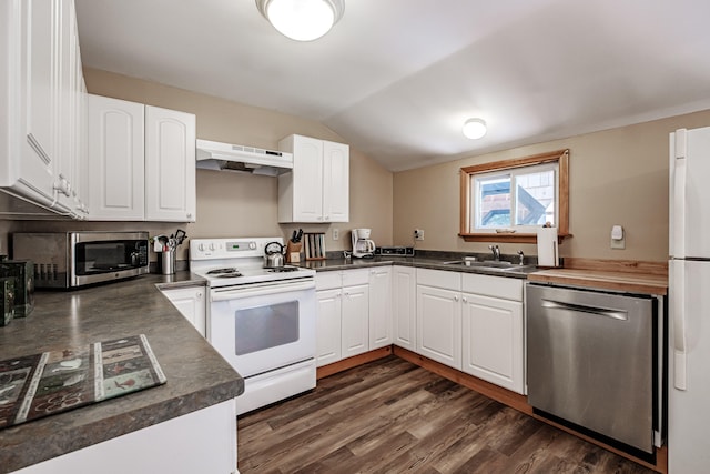 kitchen featuring white cabinets, appliances with stainless steel finishes, vaulted ceiling, and range hood