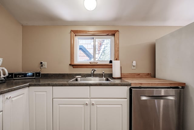 kitchen with white cabinetry, dishwasher, and sink