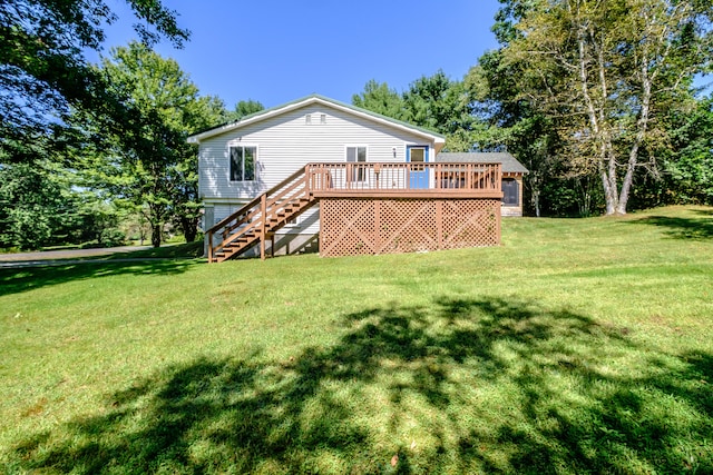 rear view of house with a yard and a wooden deck