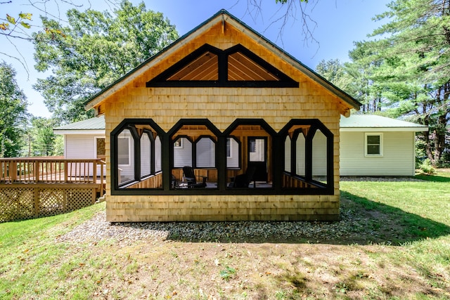 rear view of property featuring a yard and a deck