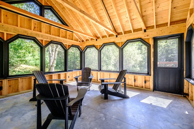 sunroom featuring lofted ceiling, wooden ceiling, and a wealth of natural light