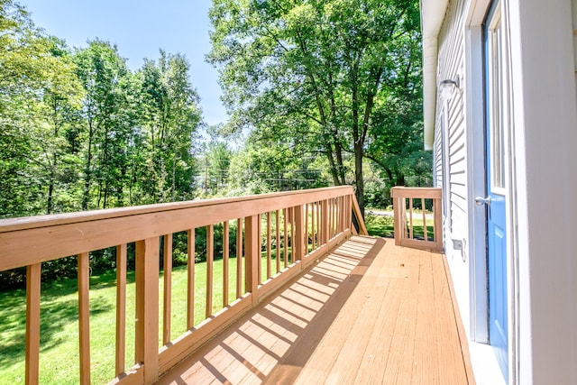 wooden deck featuring a yard