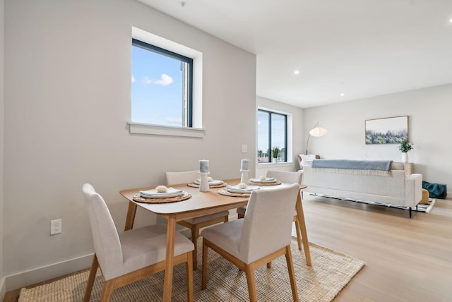 dining room featuring recessed lighting, baseboards, and light wood-type flooring