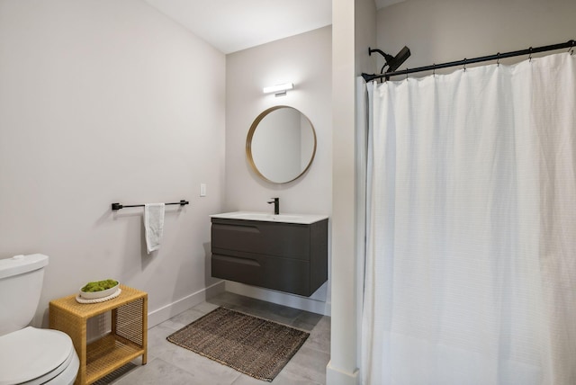 bathroom featuring vanity, toilet, baseboards, tile patterned floors, and curtained shower