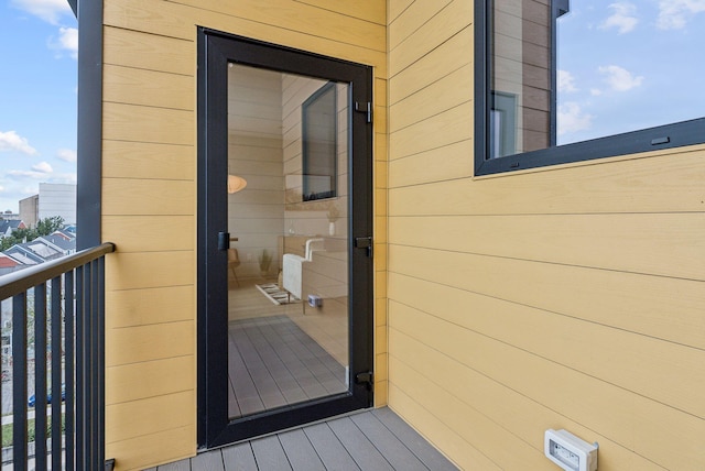 view of exterior entry featuring a balcony