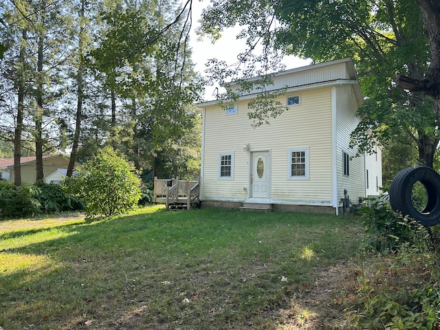 back of property with a lawn