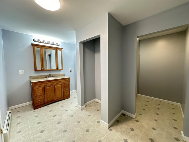 bathroom with vanity and baseboard heating