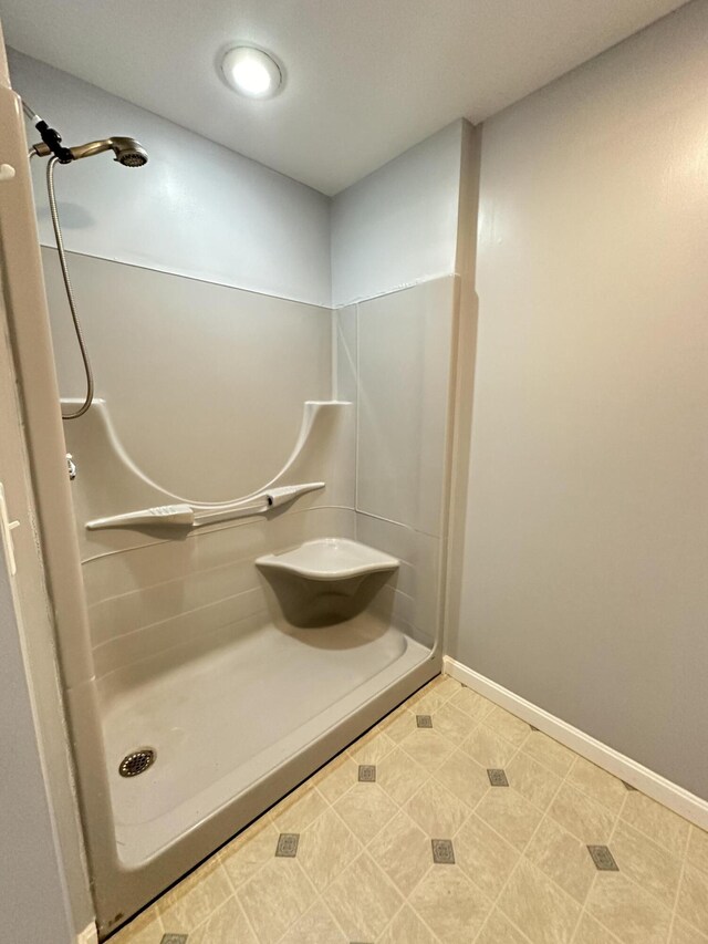 bathroom featuring a shower and tile patterned flooring