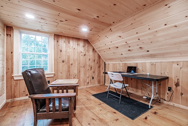 office with wooden walls, light hardwood / wood-style flooring, wood ceiling, and lofted ceiling