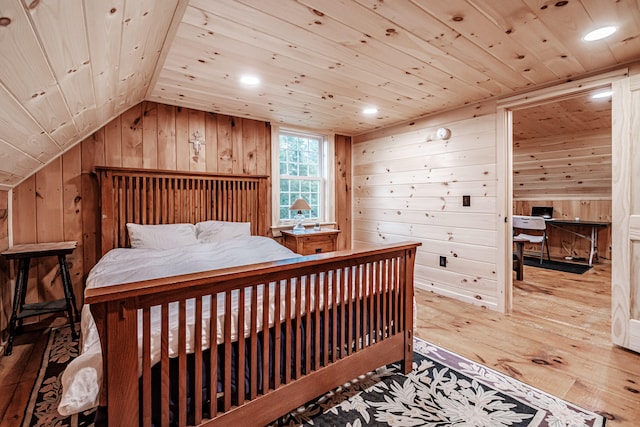 bedroom featuring wood walls, wooden ceiling, vaulted ceiling, and light wood-type flooring