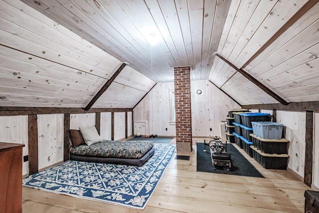 bedroom featuring lofted ceiling with beams, light hardwood / wood-style flooring, wooden walls, and wood ceiling