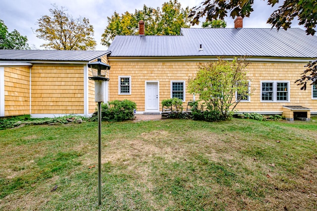 rear view of property with a yard