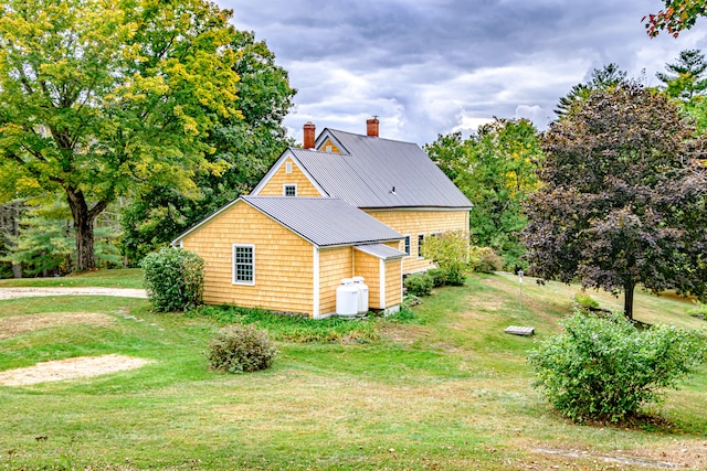 view of home's exterior featuring a yard