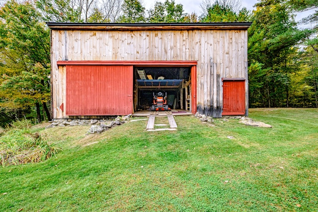 view of outdoor structure featuring a lawn