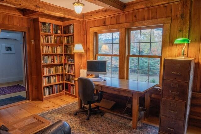 office with beamed ceiling, wood walls, and wood-type flooring