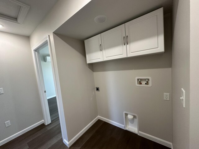 laundry area featuring cabinets, electric dryer hookup, hookup for a washing machine, and dark wood-type flooring