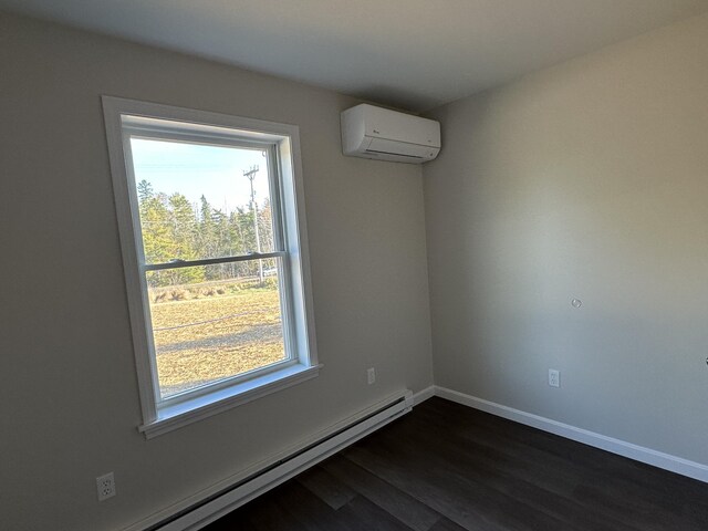 empty room with a baseboard radiator, dark hardwood / wood-style flooring, a wall mounted AC, and a wealth of natural light