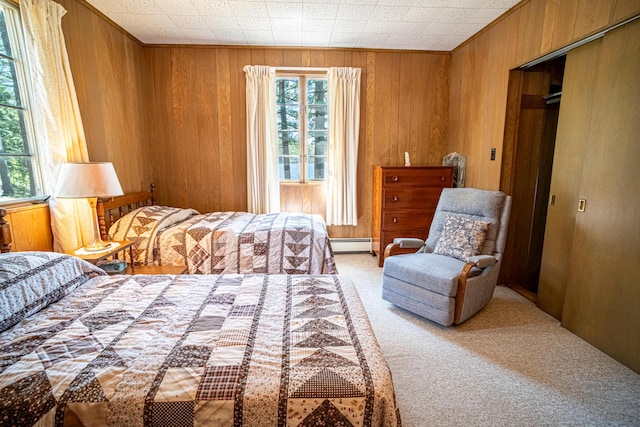 35 Middle Rd, Acton, ME 04001 - bedroom featuring a baseboard heating unit, light colored carpet, wooden walls, and a closet