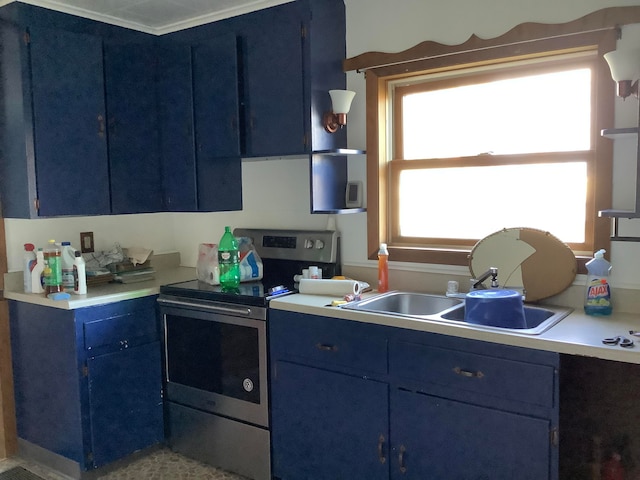 kitchen featuring blue cabinetry, sink, and electric stove