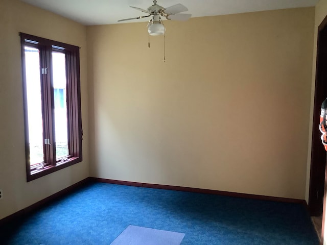 empty room featuring ceiling fan, plenty of natural light, and carpet flooring