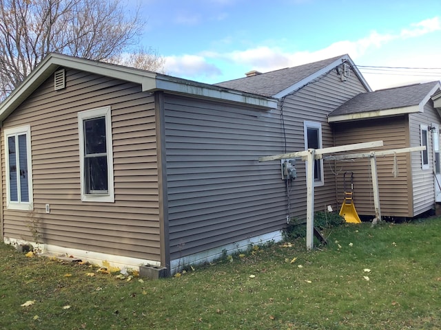 view of property exterior with a yard