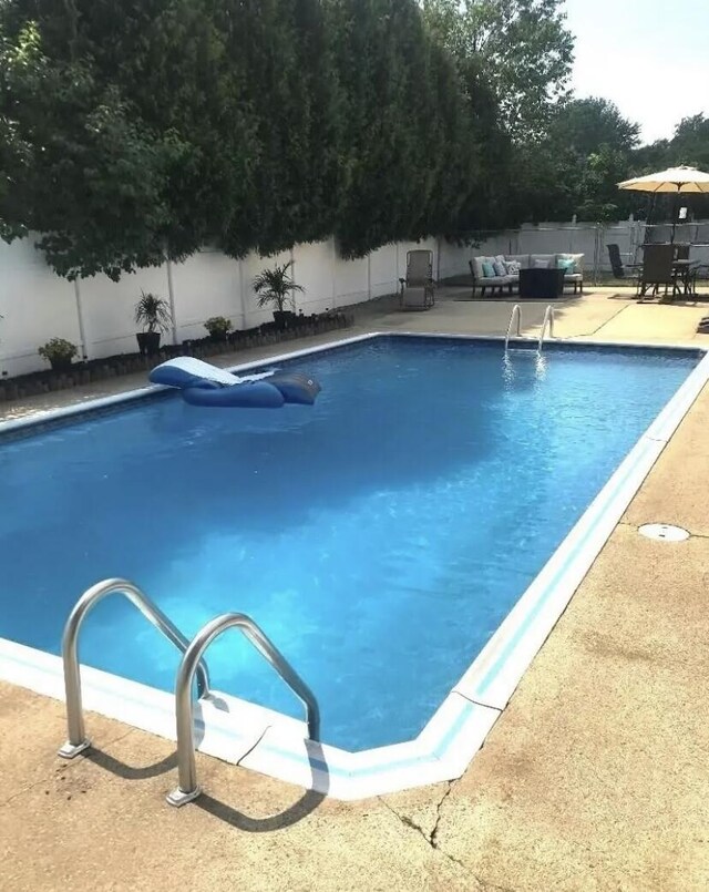 view of swimming pool with a patio area