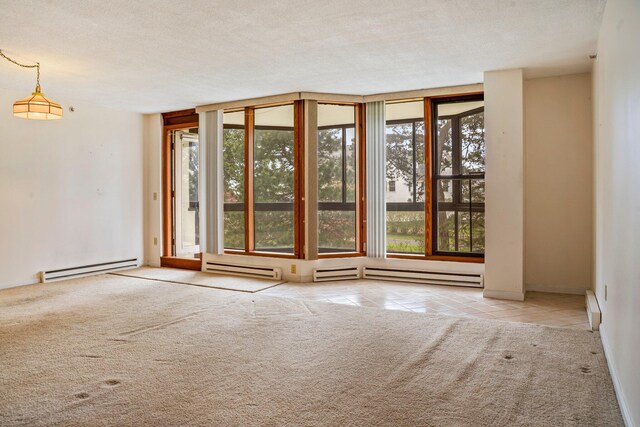 215 E Grand Ave Unit 206, Old Orchard Beach, ME 04064 - carpeted empty room with a baseboard radiator, tile patterned floors, a textured ceiling, and a baseboard heating unit