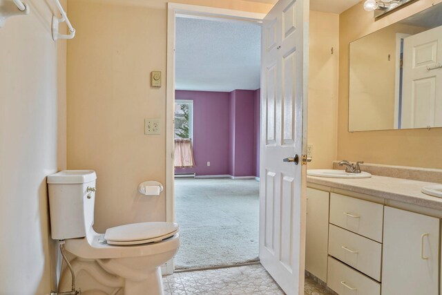 215 E Grand Ave Unit 206, Old Orchard Beach, ME 04064 - bathroom featuring toilet, vanity, and baseboard heating