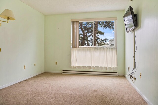 215 E Grand Ave Unit 206, Old Orchard Beach, ME 04064 - carpeted spare room featuring a baseboard heating unit and baseboards