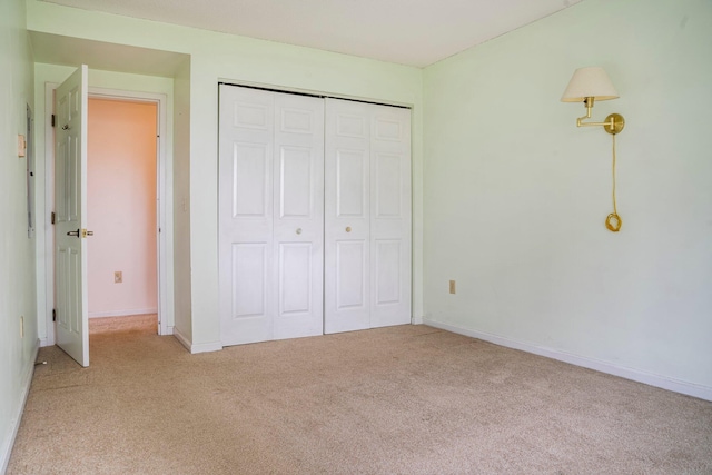 215 E Grand Ave Unit 206, Old Orchard Beach, ME 04064 - unfurnished bedroom featuring light colored carpet, a closet, and baseboards