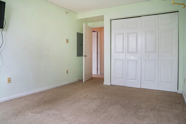215 E Grand Ave Unit 206, Old Orchard Beach, ME 04064 - unfurnished bedroom featuring electric panel, carpet, a closet, and baseboards