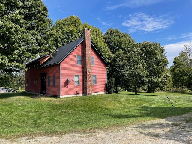 view of outbuilding featuring a yard