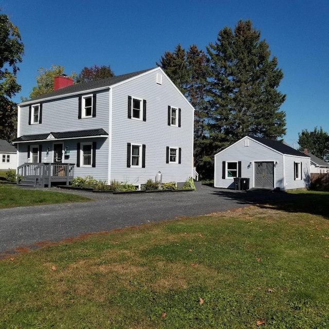 view of front of house with a wooden deck, a front lawn, and central AC unit