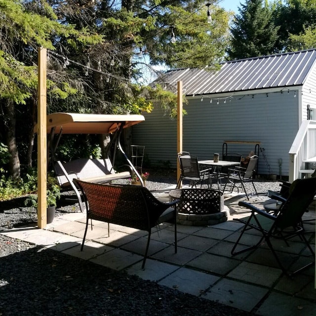 view of patio / terrace with an outdoor fire pit