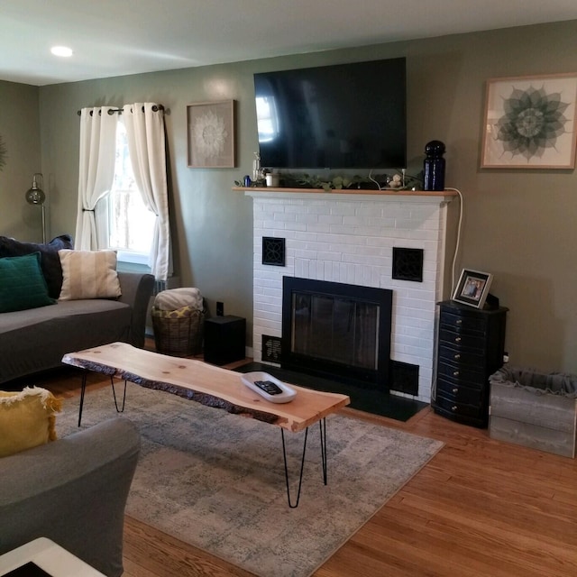 living room featuring a fireplace and hardwood / wood-style floors