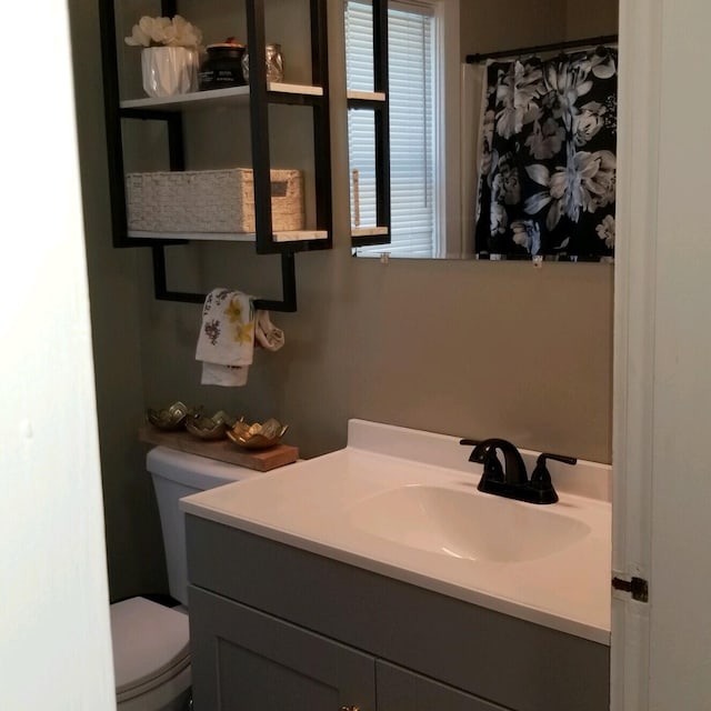 bathroom featuring vanity and toilet