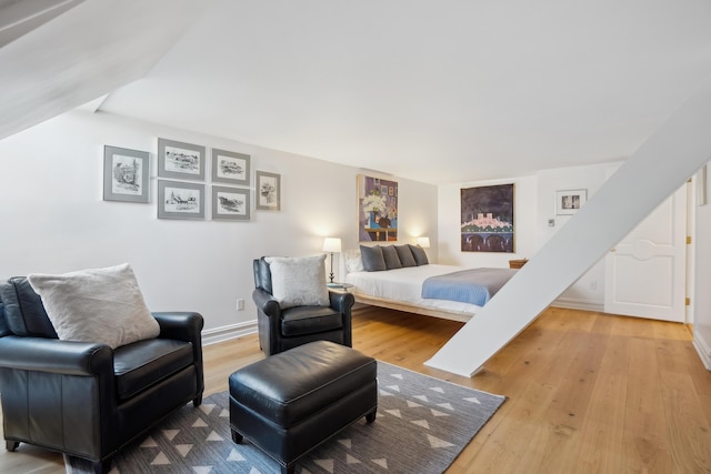 bedroom with baseboards and wood finished floors