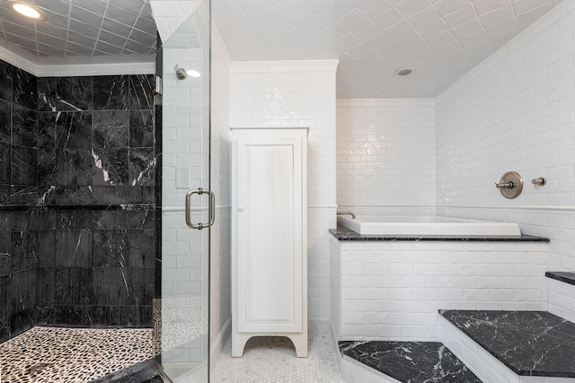 full bathroom featuring a shower stall, tile patterned flooring, a bath, ornamental molding, and tile walls