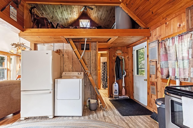 interior space with white refrigerator, wood-type flooring, wooden walls, washer / clothes dryer, and wooden ceiling