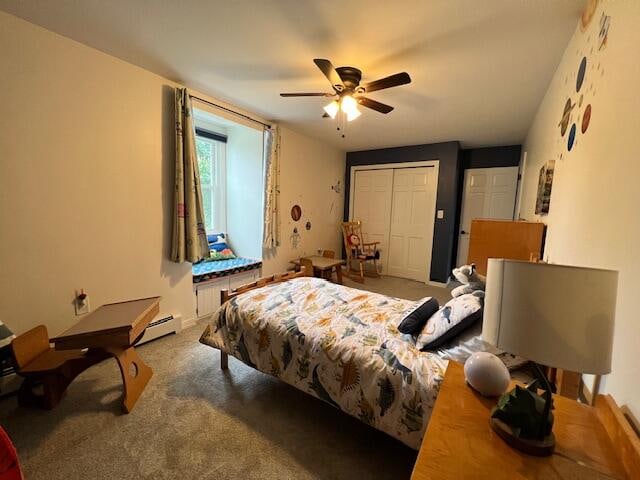 bedroom with ceiling fan, a baseboard radiator, a closet, and carpet flooring