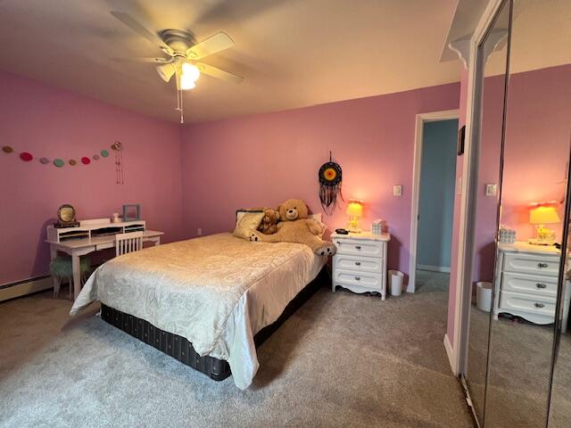 bedroom featuring ceiling fan and dark colored carpet