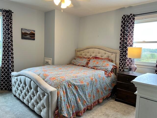 carpeted bedroom with ceiling fan