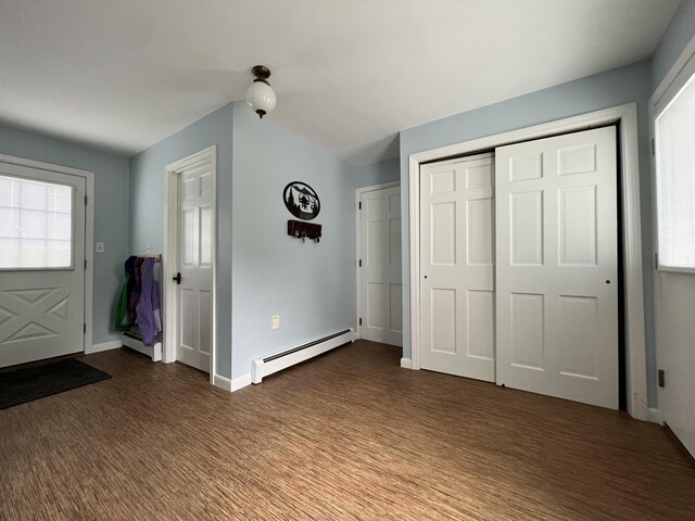 foyer entrance featuring a baseboard radiator, a wealth of natural light, and hardwood / wood-style floors