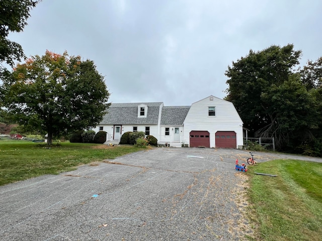 view of front of home with a front lawn and a garage