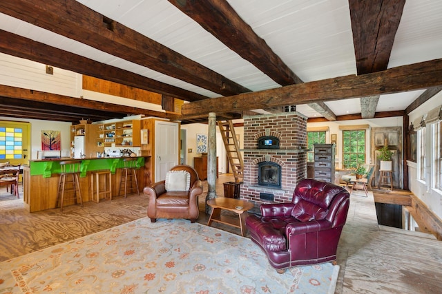 living room featuring a brick fireplace, beamed ceiling, bar, and hardwood / wood-style flooring